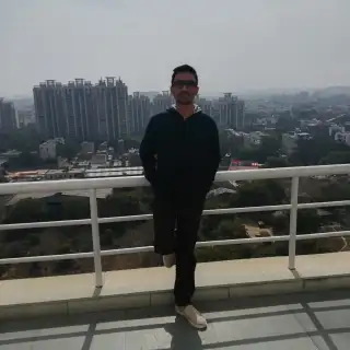 Rajendra Pareek smiling with a blurred background